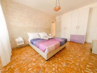 a bedroom with a bed and an orange floor at Vatican Views Elegant Spacious e Unforgettable in Rome
