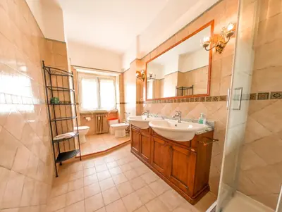 a bathroom with a sink and a mirror at Vatican Views Elegant Spacious e Unforgettable in Rome