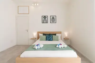 a bedroom with a large bed with three towels at Domvs Tibvrtina - Solarium Zone, Terrace, A-C, Roma in Rome