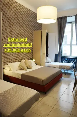 a bedroom with two beds and a sign that reads extra bed not included at Stay Smart Termini Esquilino in Rome