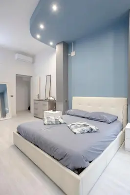 a bedroom with a bed and a table and a mirror at Lounge House Vatican - San Pietro in Rome