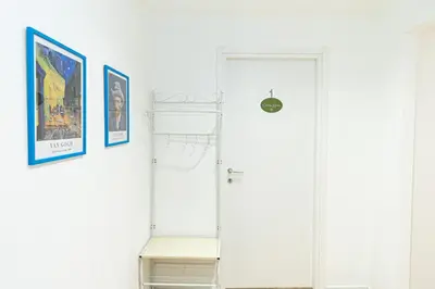 a white door in a white room with a shelf at Grace's house Roma Trastevere in Rome