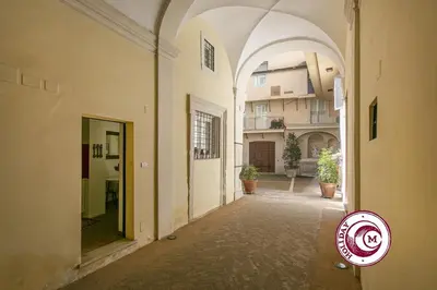an empty alley with an archway in a building at La Torre Della Scimmia nido romantico a Piazza Navona in Rome