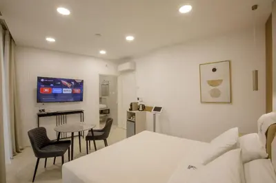 a room with a bed and a table and chairs at Cosmo Vatican Rooms in Rome