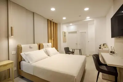 a hotel room with a bed and a table at Cosmo Vatican Rooms in Rome