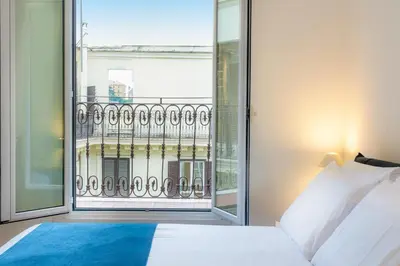 a bedroom with a bed and a large window at Amazing Via del Tritone in Rome