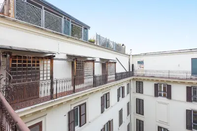 a row of white buildings with balconies at Amazing Via del Tritone in Rome