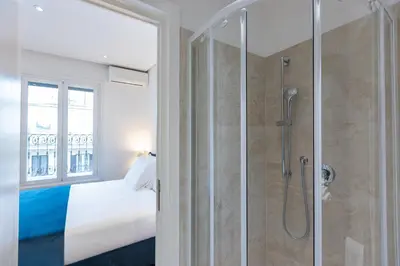 a bedroom with a shower and a bed and a window at Amazing Via del Tritone in Rome