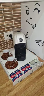 a coffeemaker sitting on top of a counter with cups at Casa Nuccia,Close to Vatican city and Gemelli in Rome