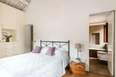 a white bedroom with a bed and a sink at Luce Trastevere Retreat by Romeloft in Rome