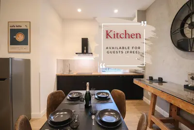 a kitchen with a table with a bottle of wine at St Peter & Vatican Luxury Suites - Boutique Suites in Rome Centre & Vatican - AC, Wifi & Metro 5 min in Rome