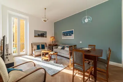 a living room with a table and a couch at La casa di Oreste al Vaticano in Rome
