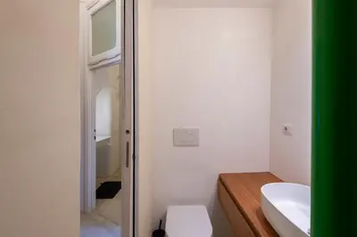 a bathroom with a white toilet and a sink at Vittorio Luxury Panoramic Apartment in Rome