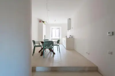 a kitchen and dining room with a table and chairs at Vittorio Luxury Panoramic Apartment in Rome