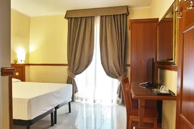 a hotel room with a bed and a window at Ghv Rooms Roma in Rome