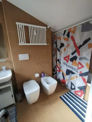 a bathroom with a toilet and a sink at Il Mulo Volante - Panoramico attico con terrazzo a Trastevere in Rome