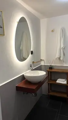 a bathroom with a white sink and a mirror at Elegant Apartment in Rome's Historic Center in Rome
