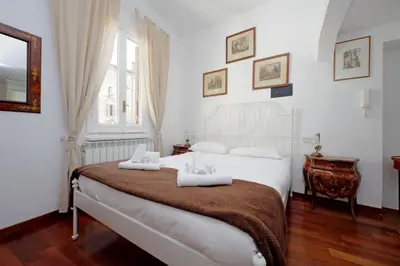 a bedroom with a bed with two towels on it at 4BNB - Navona Rooftop in Rome