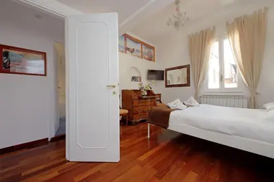 a bedroom with a large white bed and a desk at 4BNB - Navona Rooftop in Rome
