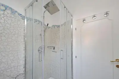a shower with a glass door in a bathroom at 4BNB - Navona Rooftop in Rome