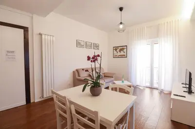 a kitchen and living room with a table and chairs at Apartments Portuense in Rome