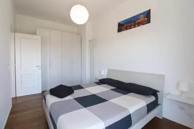 a bedroom with a bed with a checkeredkered blanket at Apartments Portuense in Rome