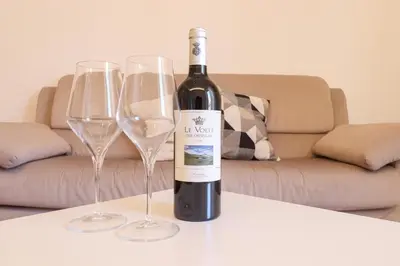 a bottle of wine sitting on a table with two wine glasses at Apartments Portuense in Rome