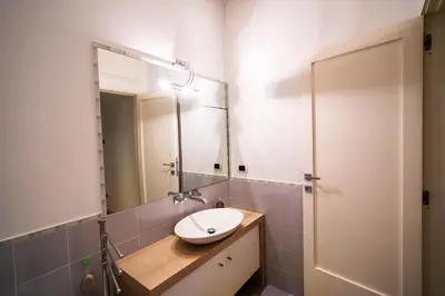 a bathroom with a sink and a mirror at San Giovanni Art Apartment in Rome