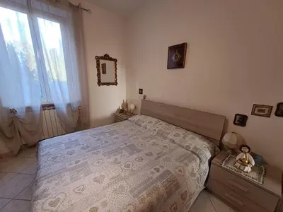 a bedroom with a large bed and a window at Da Fedelisa in Rome