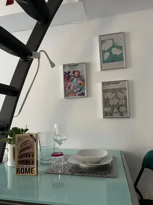 a glass table with a plate and a lamp at Brina-House, Mini Apartment in Rome