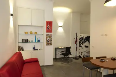a living room with a red couch and a table at Casa Vacanze Fausta in Rome