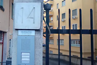 a clock on a pole next to a fence at Casa Vacanze Fausta in Rome