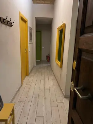 an empty hallway with yellow and green doors at GA Holidays Home2 in Rome