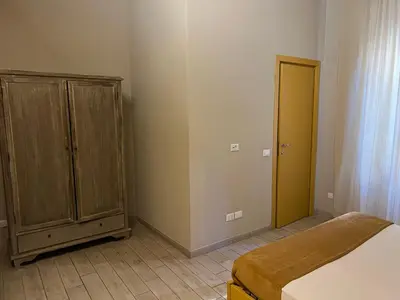 a bedroom with a bed and a wooden cabinet at GA Holidays Home2 in Rome