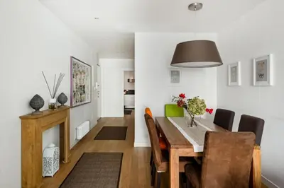 a dining room and living room with a table and chairs at Charming apartment near Villa Borghese in Rome