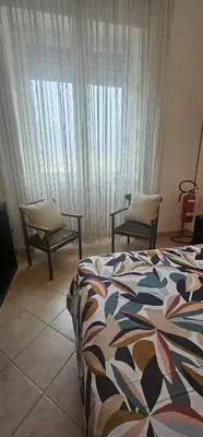 a bedroom with a bed and a table and a chair at Casa Kathy Rome in Rome