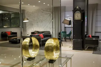 a lobby with a clock and gold sculptures on display at Hotel Marc'Aurelio in Rome
