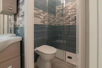a bathroom with a toilet and a shower at GuestHost - Sweety Apartment near MM Ottaviano in Rome