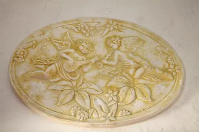 a gold coin with an angel and flowers on it at Hotel Hollywood in Rome