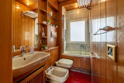 a bathroom with a sink and a toilet and a tub at Along the Tiber Apartment in Rome