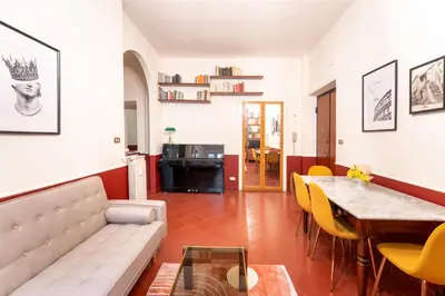 a living room with a couch and a table at Maroon Flat Colosseo, 800 mt from Amphitheater in Rome