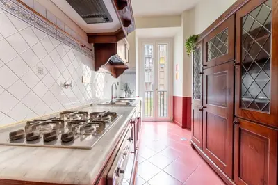 a kitchen with a stove and a sink at Maroon Flat Colosseo, 800 mt from Amphitheater in Rome