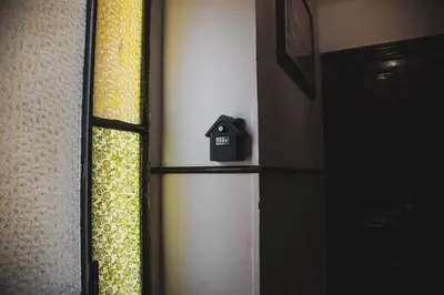a black alarm clock sitting on a shelf next to a door at Roma Vatican-Ottaviano's Homies in Rome