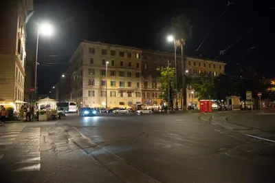 a city street at night with a building at Roma Vatican-Ottaviano's Homies in Rome
