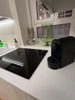 a kitchen with a black microwave on a counter at Antica Dimora Luxury in Rome