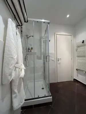 a bathroom with a shower with a glass shower stall at Roman Interlude in Rome