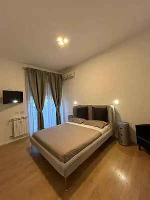 a bedroom with a bed and a large window at Roman Interlude in Rome