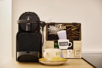 a coffee maker and a cup on a table at Casa di borgo in Rome