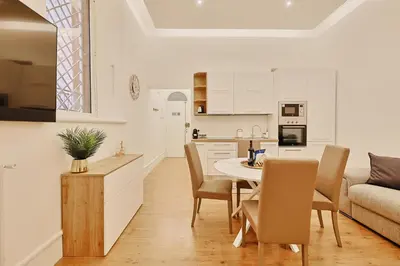 a kitchen and living room with a table and chairs at Casa di borgo in Rome