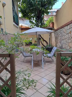 a table and chairs with an umbrella on a patio at Romeo&Giulietta in Rome